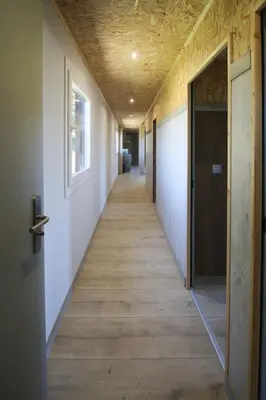 a hallway with a wooden floor and a ceiling at CELTAINER in Maceda
