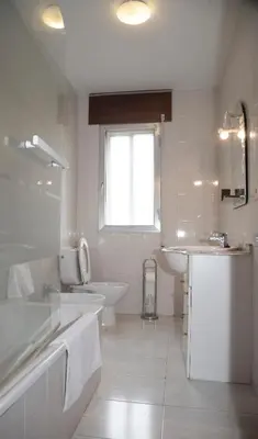 a white bathroom with a sink and a tub and a toilet at Pico da Costa in Barreiros