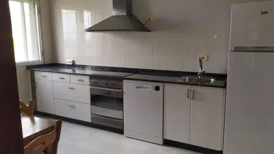 a kitchen with a sink and a stove top oven at Pico da Costa in Barreiros