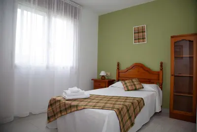 a bedroom with a bed and a window at Pico da Costa in Barreiros