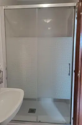 a glass shower in a bathroom with a sink at Pico da Costa in Barreiros