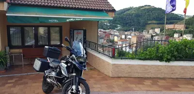 a motorcycle parked in front of a building at Hotel Alina in Cangas del Narcea