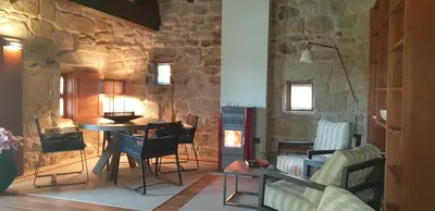 a living room with a table and chairs at Casa Rural Rectoral Santa Baia in Boimorto