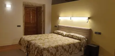 a small bedroom with a bed in a room at Casa Rural Rectoral Santa Baia in Boimorto