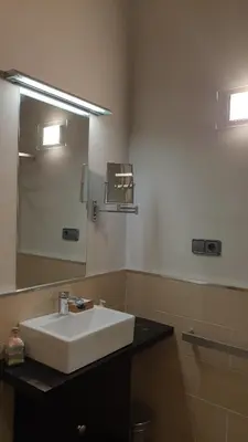 a bathroom with a white sink and a mirror at Casa Rural Rectoral Santa Baia in Boimorto