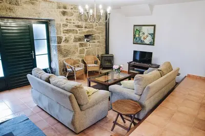 a living room with two couches and a table at Casa da Labaceira in Santo Tomé