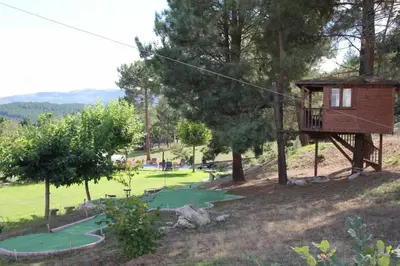 a tree house with a putting green in a park at A Forxa - Casa Ferrador (Ribeira Sacra) in Sober