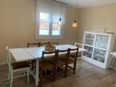 a dining room with a white table and chairs at Casa Otilia - Rural - Camino de Santiago - Arzúa in Arzúa
