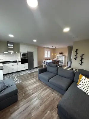 a living room with a couch and a kitchen at Casa Otilia - Rural - Camino de Santiago - Arzúa in Arzúa