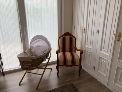 a room with a chair and a crib and a window at Casa Otilia - Rural - Camino de Santiago - Arzúa in Arzúa