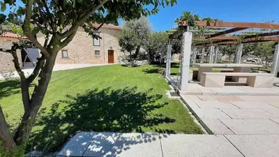 a garden with a picnic table and a pavilion at O Forno - Casa Ferrador (Ribeira Sacra) in Sober