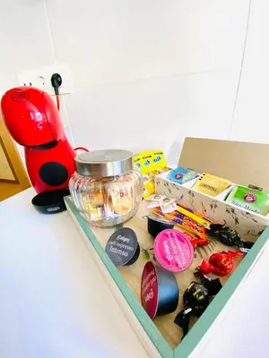 a counter top with a box and a red blender at ARENAL HOME, PARKING GRATIS in Lugo
