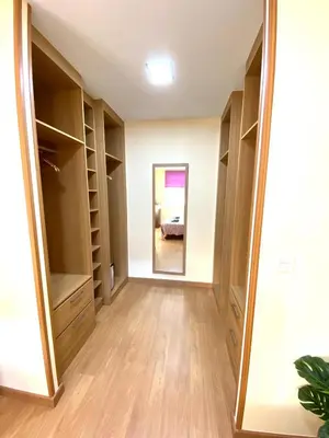 a walk in closet with a mirror and a bed at ARENAL HOME, PARKING GRATIS in Lugo