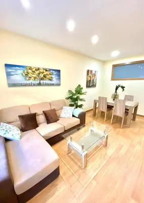a living room with a couch and a table at ARENAL HOME, PARKING GRATIS in Lugo