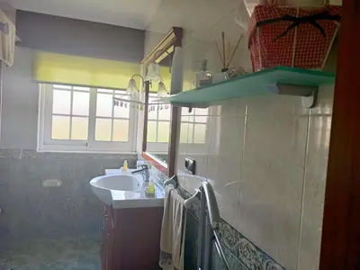 a bathroom with a sink and a mirror at O Seixo 2 in Mugardos
