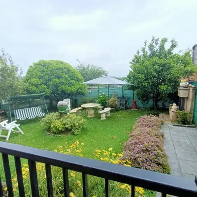 a backyard with a table and chairs and a garden at O Seixo 2 in Mugardos