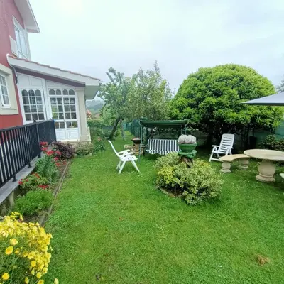 a yard with a bench and a table and chairs at O Seixo 2 in Mugardos