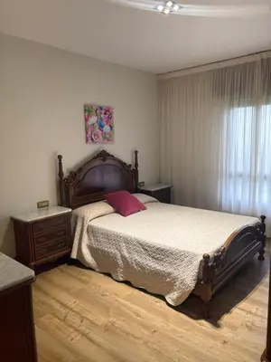 a bedroom with a large bed and a window at Casa Hipólito in A Estrada