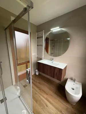 a bathroom with a sink and a toilet and a mirror at Casa Hipólito in A Estrada