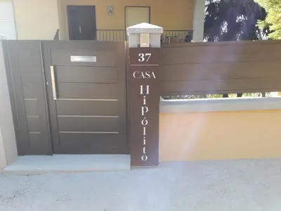 a gate to a house with a sign on it at Casa Hipólito in A Estrada