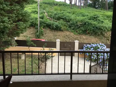 a balcony with a bench and flowers at Casa Hipólito in A Estrada