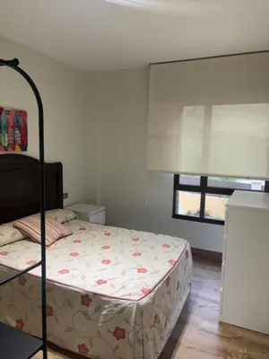 a bedroom with a bed and a window at Casa Hipólito in A Estrada