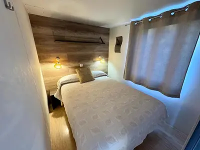 a small bedroom with a bed and a window at La Villa del Karting in El Teso
