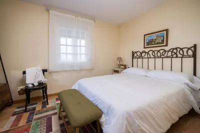 a bedroom with a large white bed and a window at Aldeade in Ferreira de Panton