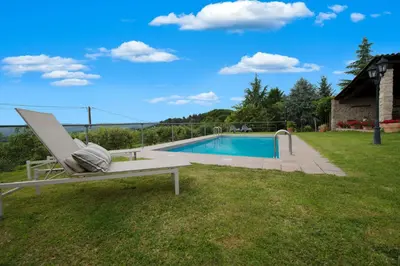 a swimming pool in a yard with a chair next to it at Aldeade in Ferreira de Panton
