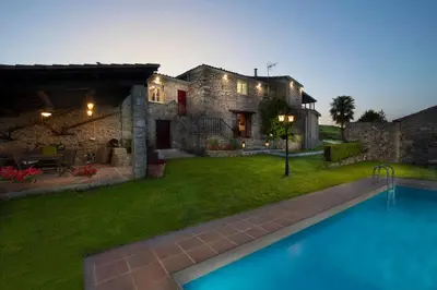 a house with a swimming pool in front of a yard at Aldeade in Ferreira de Panton