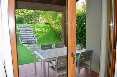 a door leading to a patio with a table and chairs at Precioso adosado en Urbanización con campo de golf in Miño