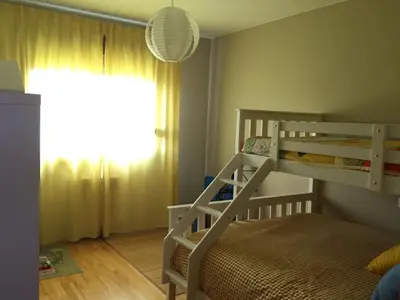 a bedroom with two bunk beds and a window at Precioso adosado a 5 minutos de la playa de Miño in Miño