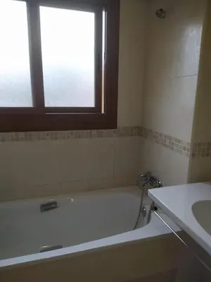 a bathroom with a tub and a sink and a window at Precioso adosado a 5 minutos de la playa de Miño in Miño
