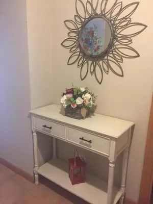 a dressing table with a mirror and flowers on it at Precioso adosado a 5 minutos de la playa de Miño in Miño