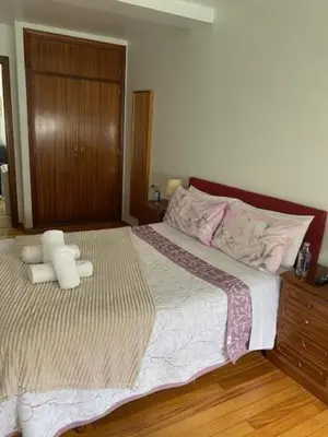 a bedroom with a bed with two teddy bears on it at Apartamento próximo a la catedral in Santiago de Compostela