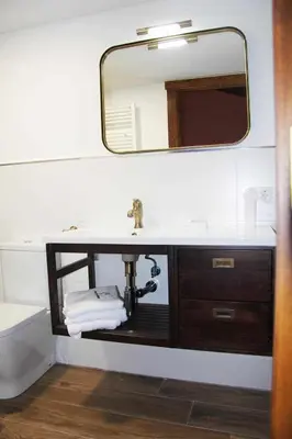 a bathroom with a sink and a mirror at O Yunque - Casa Ferrador (Ribeira Sacra) in Sober
