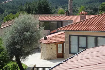 a house with a red roof and a tree at O Yunque - Casa Ferrador (Ribeira Sacra) in Sober