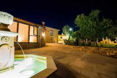 a hot tub in the middle of a yard at night at O Yunque - Casa Ferrador (Ribeira Sacra) in Sober