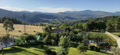 a view of a farm with mountains in the background at Casa Rural FULGUERA in El Espino