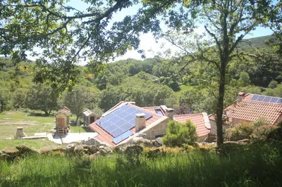 a group of houses with solar panels on their roofs at O XARDÍN DA FRAGA in A Lama