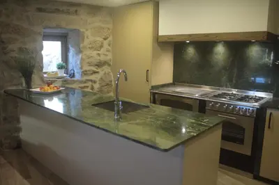 a kitchen with a sink and a stove at O XARDÍN DA FRAGA in A Lama