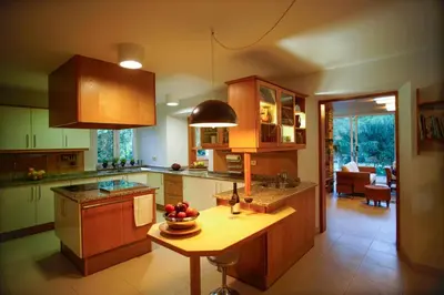 a kitchen with a table with a bowl of fruit on it at O Casal das Árbores in Santiago de Compostela