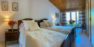 a bedroom with two beds and a window at O Casal das Árbores in Santiago de Compostela