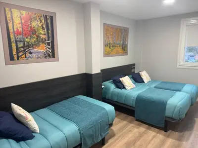 a room with two beds and a couch in it at Pension San Anton in Melide