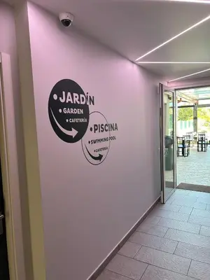 a white wall with a sign on it at Pension San Anton in Melide