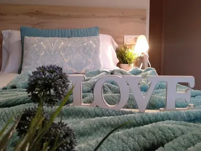 a bed with a sign that says love on it at Km101 in Baamonde