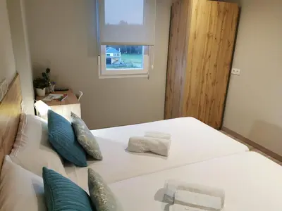 a bedroom with a white bed with blue pillows at Km101 in Baamonde