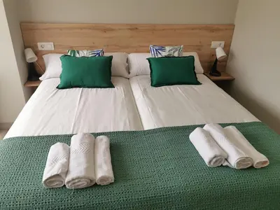 a bedroom with two beds with towels on them at Km101 in Baamonde