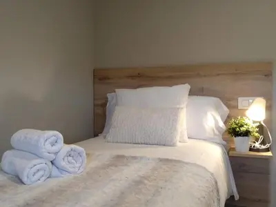 a bedroom with a bed with towels on it at Km101 in Baamonde