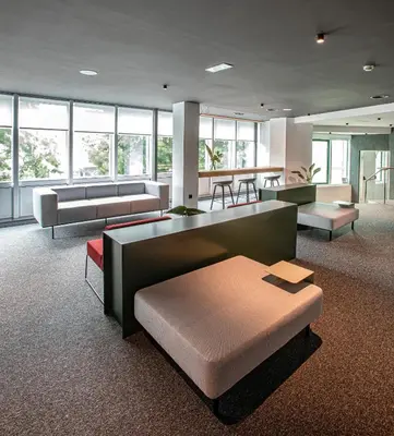 a large room with couches and tables and windows at Hotel Forum Ceao in Lugo